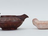 a small bowl and a small teapot sitting next to each other