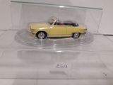 a yellow toy car in a clear display case