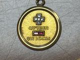 a gold medal with a cross on it sitting on a table