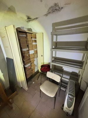 a room with shelves and a chair in it