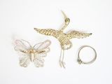 two rings and a ring holder with a bird on it