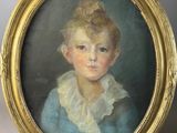 portrait of a young girl in a blue dress in a gold frame
