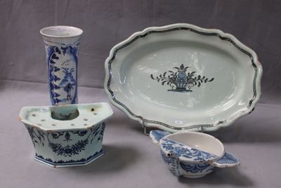 three pieces of blue and white pottery sitting on a table