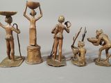 four bronze figurines of people with a dog and a cat