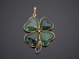 a green jade four leaf clover pendant on a black background