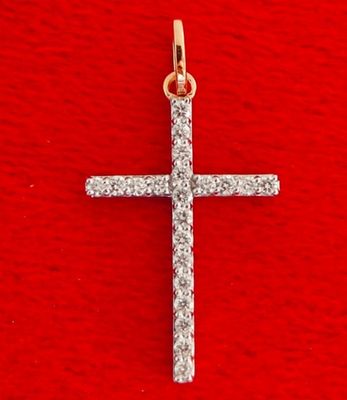 a diamond cross pendant on a red background