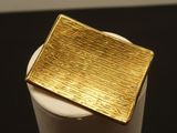 a gold plate sitting on top of a white cup