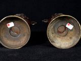 pair of antique brass candlesticks with red and white labels