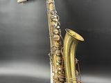 a close up of a saxophone sitting on top of a table