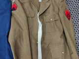 two uniforms are laid out on the floor next to each other
