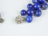 two pieces of lapis and diamond jewelry on a white surface