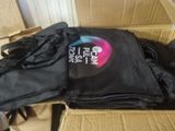 a cardboard box filled with black clothes and a black t - shirt