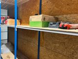 a shelf with boxes and tools on it in a room