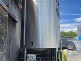 une photo d'une grande cuve en acier inoxydable devant un bâtiment