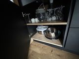 a black cupboard with dishes and glasses on it