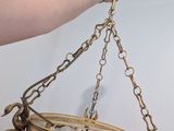 a person holding a clock hanging from a chain