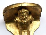 a gold statue of a man holding a soccer ball