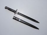 two knives are laying next to each other on a white surface