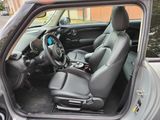 the interior of a small car with a steering wheel and a dashboard