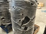 many rolls of plastic wrapped up on a pallet in a warehouse