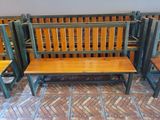 four wooden benches in a row next to each other