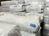a large pile of white bags sitting on top of a pallet