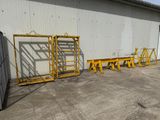 several yellow ladders that are outside of a building
