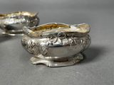 pair of silverplated sugar and creamers on a table