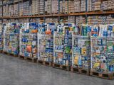 a large amount of sodas stacked on pallets in a warehouse