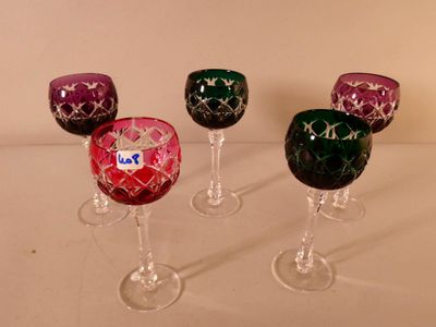 three wine glasses are lined up in a row on a table
