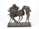 a bronze statue of a man riding a horse with a dog