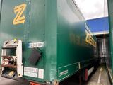 a large green truck that is parked in a parking lot