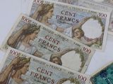 five different bank notes on the table with one of them being used