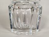 a clear glass jar with a black lid on a table