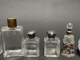 five bottles of perfume sitting next to each other on a table