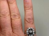 a woman ' s hand with a ring on it