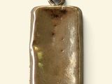 an image of a gold pendant with a rectangular shape on a white background