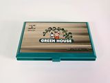 a green house business card holder on a white surface