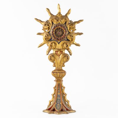an image of a golden clock on a pedestal with a white background