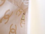 a close up of a handbag with a gold pin on it