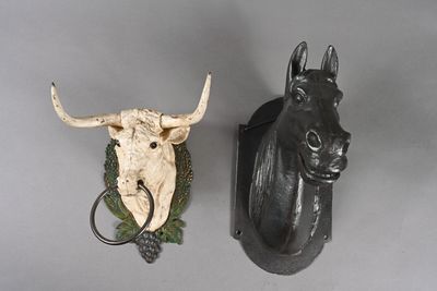 two animal heads mounted on the wall next to each other