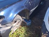 a car that has been damaged and is sitting in the grass