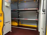 a yellow van with shelves in the back of it