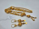 a gold necklace and earrings with a tag on it