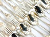 a lot of silver spoons and spoon spoons on a table