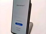 a close up of a cell phone sitting on top of a table