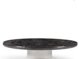 a close up of a black and white marble cake on a white pedestal
