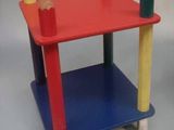 a red table with pencils on it and a blue table with pencils on it