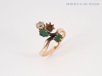 an image of a gold ring with green and white stones