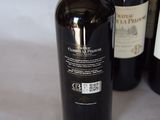 several bottles of wine are lined up on a table